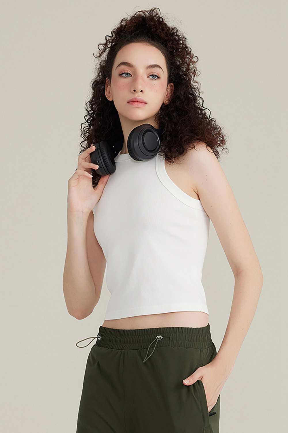 Fitted High-Neck Ribbed Cropped Tank Top in White - three-quarter front modeled view