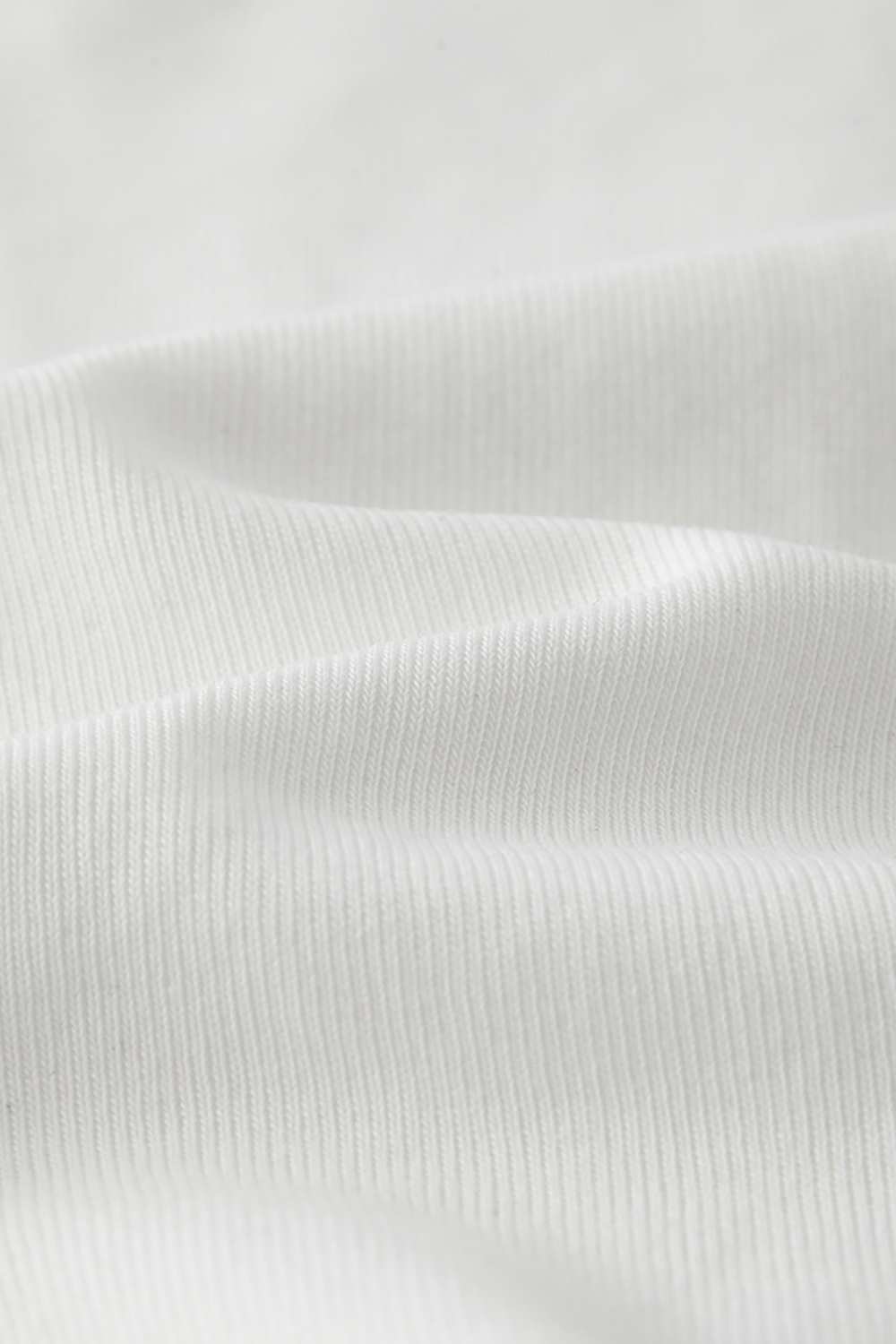 Fitted High-Neck Ribbed Cropped Tank Top in White - fabric texture close-up