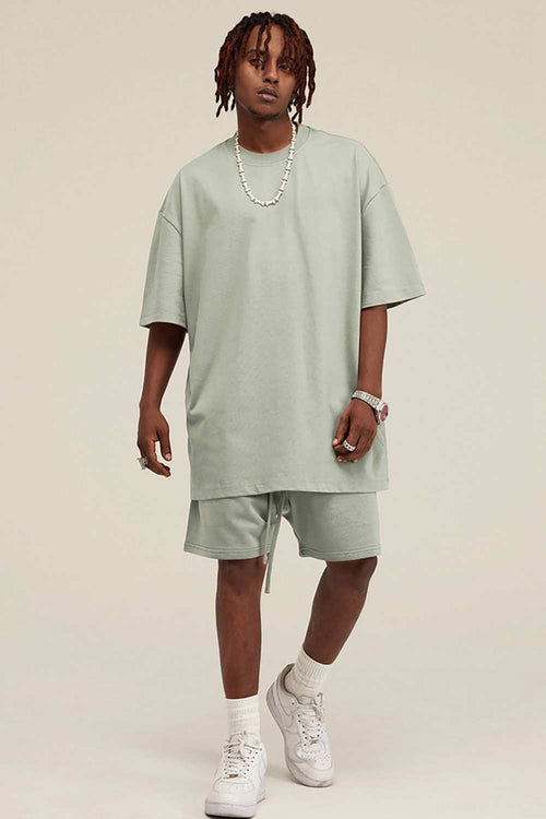 Heavyweight Cotton-Blend Relaxed Sweat Shorts in Halo Green - full-length front modeled view
