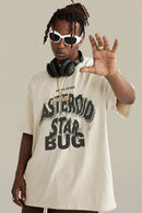 Washed Layered-Letter Graphic Relaxed Cotton T-Shirt in Gray Apricot - front modeled close-up