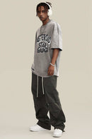 Washed Layered-Letter Graphic Relaxed Cotton T-Shirt in Medium Gray - full-length front modeled view