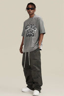 Washed Layered-Letter Graphic Relaxed Cotton T-Shirt in Medium Gray - full-length front modeled view