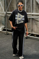 Washed Distressed-Lettering Boxy Graphic T-Shirt in Black - full-length front modeled view