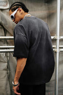 Washed Distressed-Lettering Boxy Graphic T-Shirt in Black - rear three-quarter modeled view