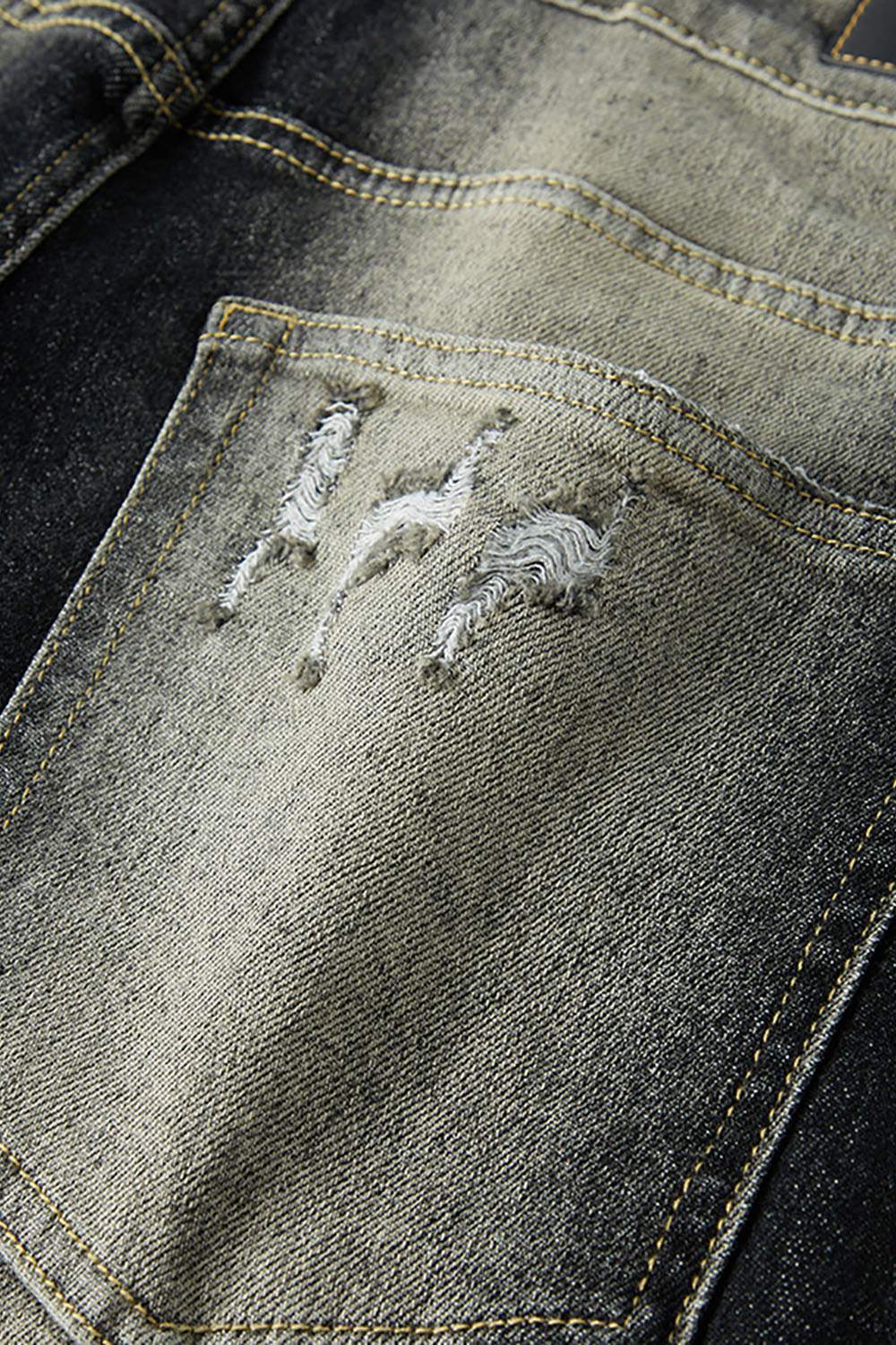 Washed Distressed Panel-Seam Flare Jeans in Black - fabric texture close-up