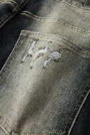 Washed Distressed Panel-Seam Flare Jeans in Black - fabric texture close-up