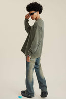 Washed Distressed Panel-Seam Flare Jeans in Denim Blue - side modeled view