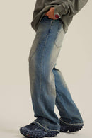 Washed Distressed Panel-Seam Flare Jeans in Denim Blue - three-quarter front modeled view