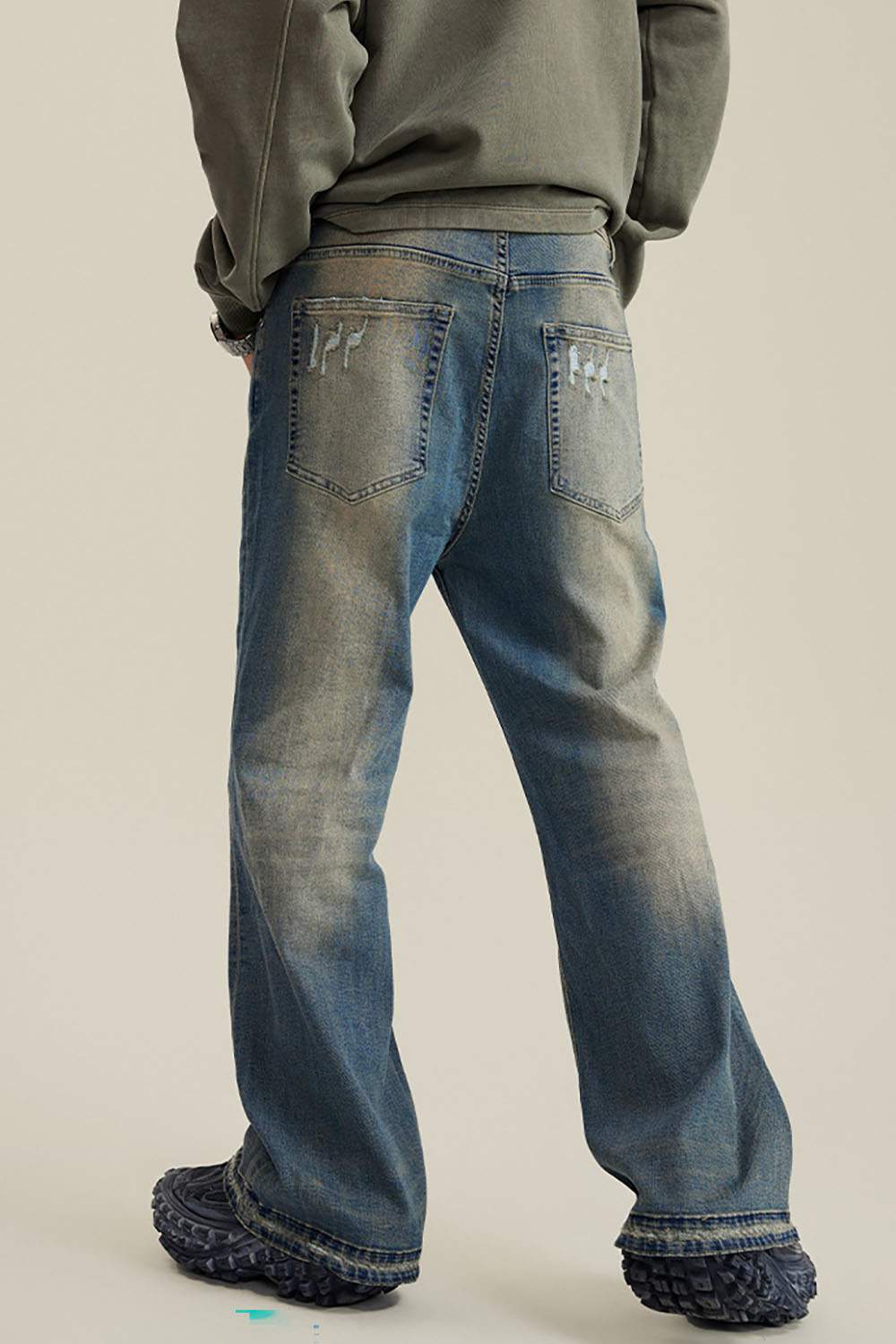 Washed Distressed Panel-Seam Flare Jeans in Denim Blue - back modeled view