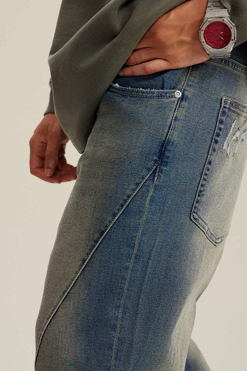 Washed Distressed Panel-Seam Flare Jeans in Denim Blue - back pocket detail