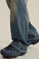 Washed Distressed Panel-Seam Flare Jeans in Denim Blue - leg opening detail