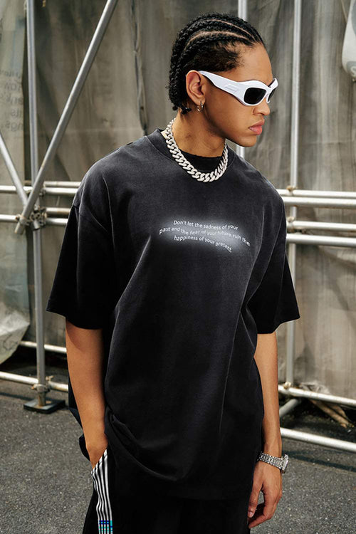 Washed Distressed-Neck Graphic Cotton T-Shirt in Black - front modeled close-up