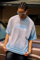 Washed Distressed-Neck Graphic Cotton T-Shirt in Blue - front modeled view