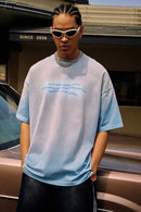 Washed Distressed-Neck Graphic Cotton T-Shirt in Blue - full-length front modeled view