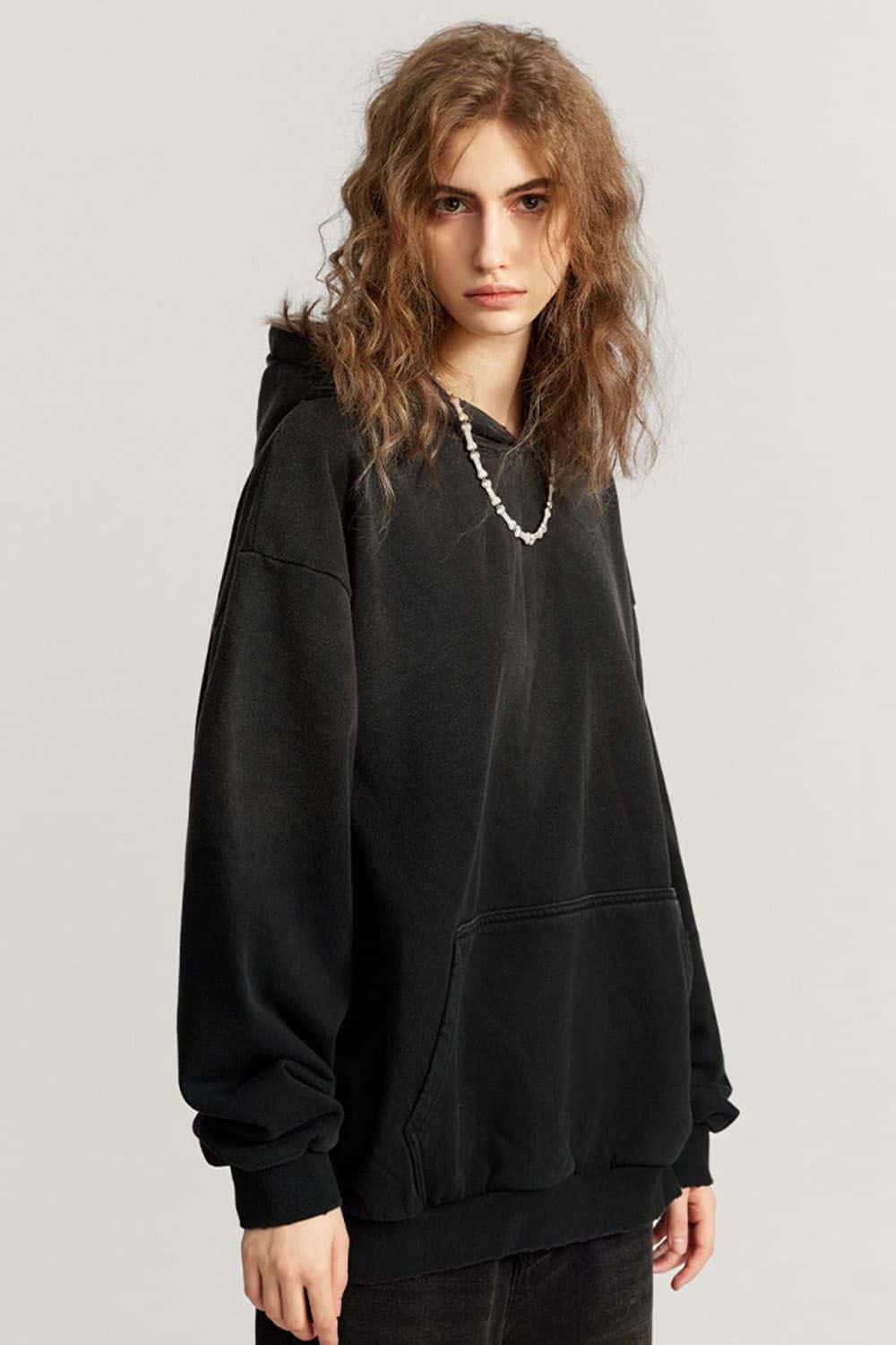 Ultra-Heavyweight Gradient-Wash Distressed Hoodie in Active Black - three-quarter front modeled view