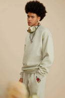 Washed Fleece-Lined Relaxed Crew-Neck Sweatshirt in Gray Apricot - three-quarter front modeled view