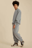 Washed Fleece-Lined Relaxed Crew-Neck Sweatshirt in Medium Gray - full-length side modeled view