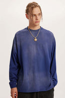 Washed Drop-Shoulder Long-Sleeve Cotton T-Shirt in Blue - front modeled close-up