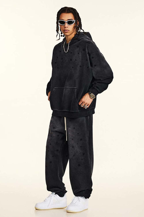 Washed Paint-Splatter Pullover Hoodie in Black - full-length front modeled view