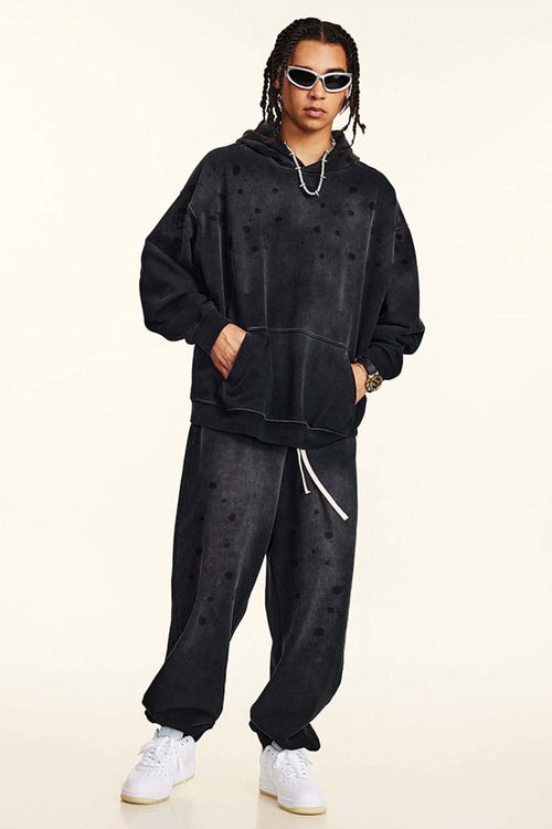 Washed Paint-Splatter Pullover Hoodie in Black - full-length front modeled view