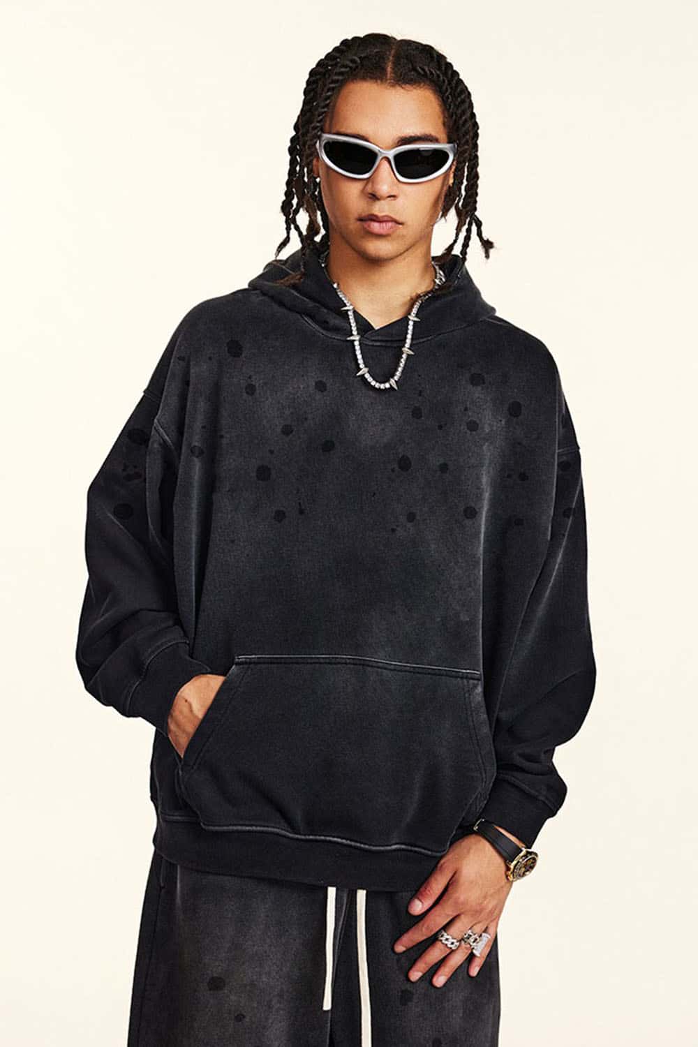 Washed Paint-Splatter Pullover Hoodie in Black - front modeled view