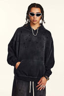 Washed Paint-Splatter Pullover Hoodie in Black - front modeled view