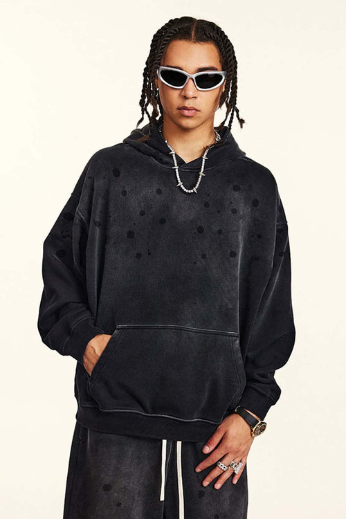 Washed Paint-Splatter Pullover Hoodie in Black - front modeled view