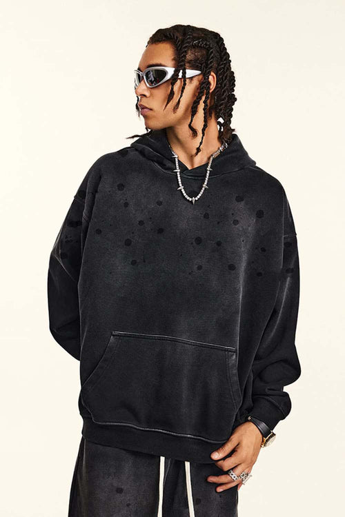 Washed Paint-Splatter Pullover Hoodie in Black - front modeled view