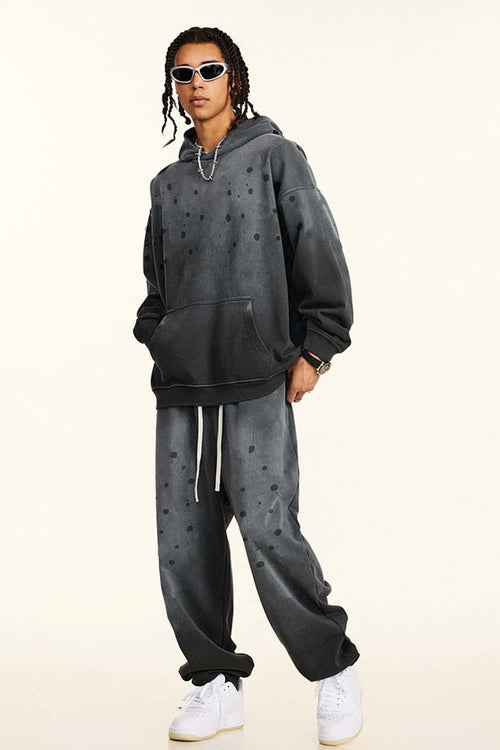Washed Paint-Splatter Pullover Hoodie in Dark Gray - three-quarter front modeled view