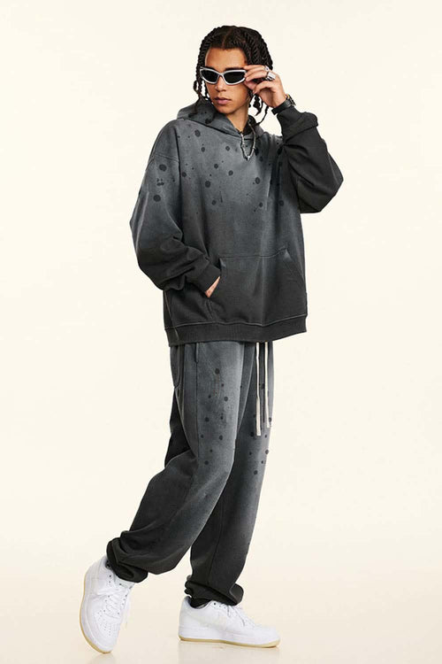Washed Paint-Splatter Pullover Hoodie in Dark Gray - front modeled view