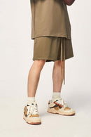 Heavyweight Cotton Relaxed-Fit Drawstring Shorts in Brown - three-quarter front modeled view