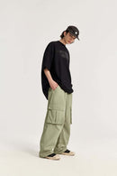 Waterproof Multi-Pocket Wide-Leg Cargo Pants in Grayish Green - full-length front modeled view