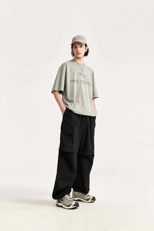 Convertible Multi-Pocket Cargo Pants in Black - three-quarter front modeled view