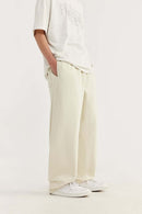 Heavyweight Cotton-Blend Relaxed Straight-Leg Sweatpants in Rice Apricot - three-quarter front modeled view