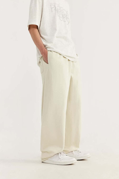 Heavyweight Cotton-Blend Relaxed Straight-Leg Sweatpants in Rice Apricot - three-quarter front modeled view