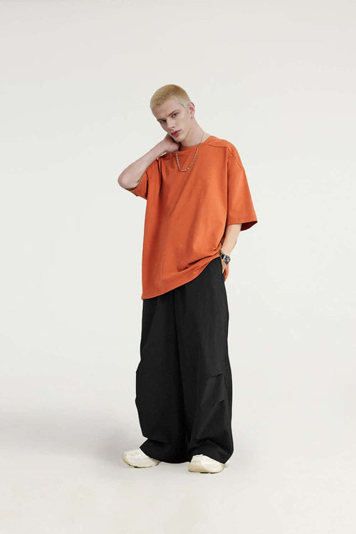 Layered-Pocket Drawstring Wide-Leg Pants in Black - full-length front modeled view