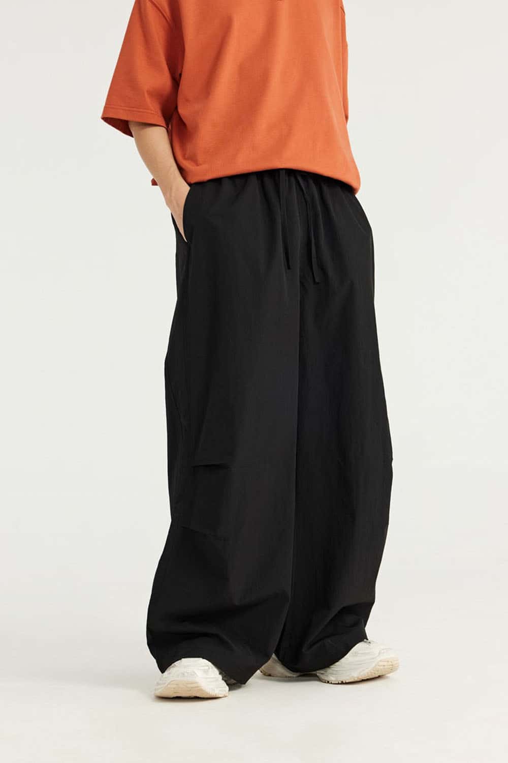 Layered-Pocket Drawstring Wide-Leg Pants in Black - front modeled view