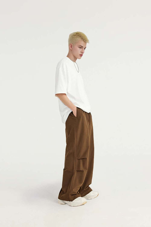 Layered-Pocket Drawstring Wide-Leg Pants in Brown - full-length side modeled view