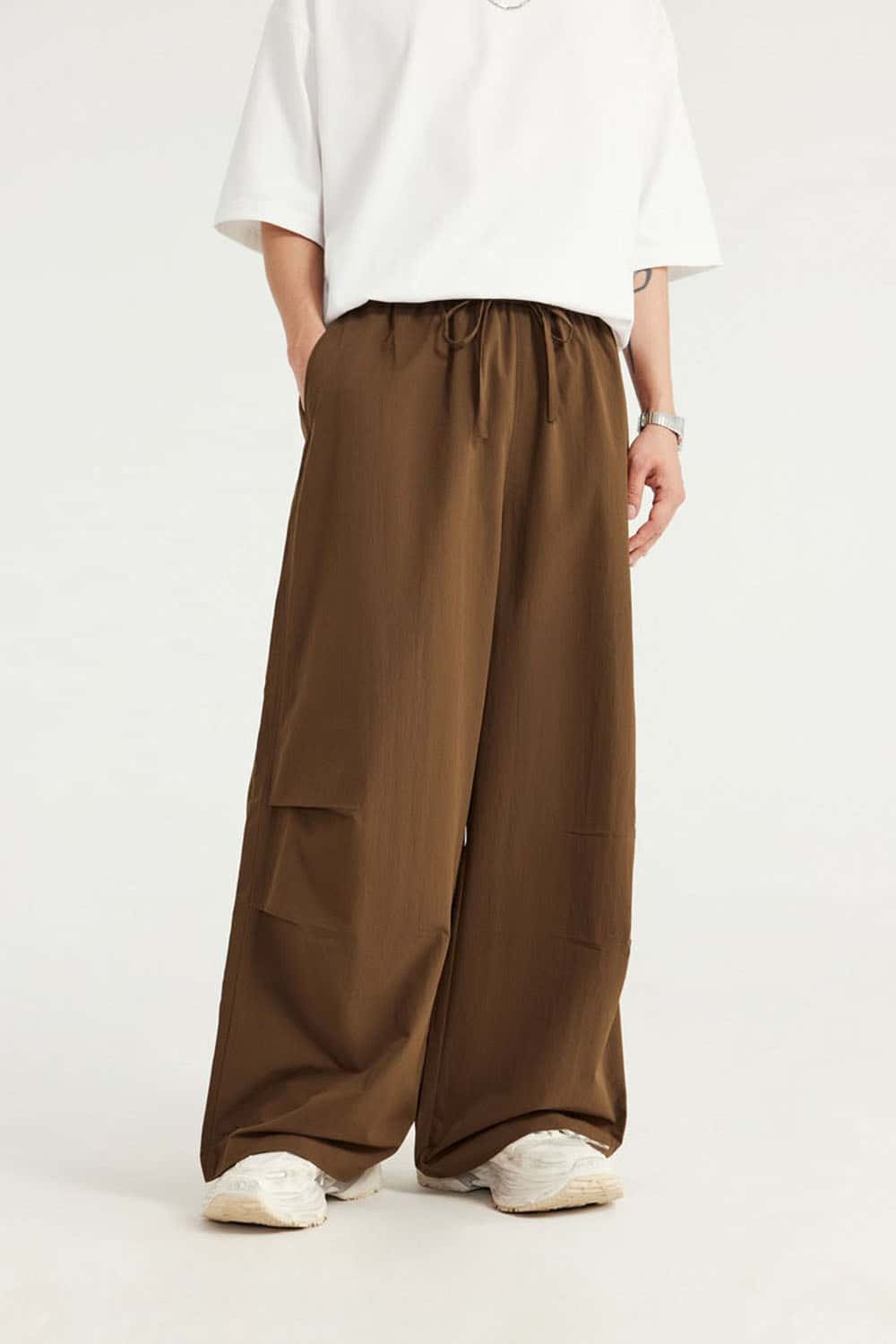 Layered-Pocket Drawstring Wide-Leg Pants in Brown - front modeled view