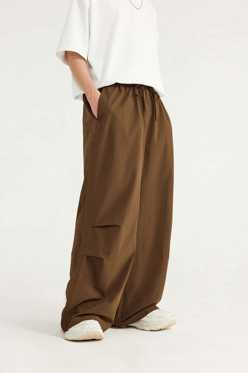 Layered-Pocket Drawstring Wide-Leg Pants in Brown - front modeled view