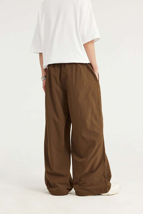 Layered-Pocket Drawstring Wide-Leg Pants in Brown - full-length back modeled view