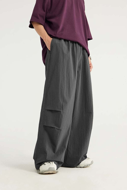 Layered-Pocket Drawstring Wide-Leg Pants in Dark Gray - front modeled view