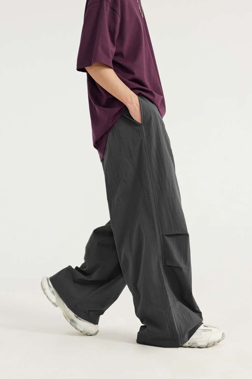 Layered-Pocket Drawstring Wide-Leg Pants in Dark Gray - full-length side modeled view
