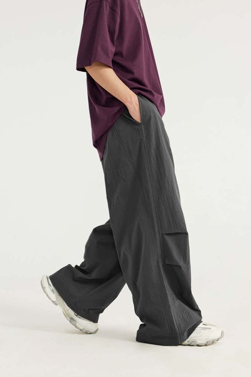 Layered-Pocket Drawstring Wide-Leg Pants in Dark Gray - full-length side modeled view