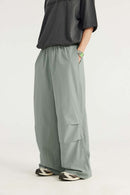 Layered-Pocket Drawstring Wide-Leg Pants in Grayish Green - front modeled view