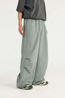 Layered-Pocket Drawstring Wide-Leg Pants in Grayish Green - three-quarter front modeled view