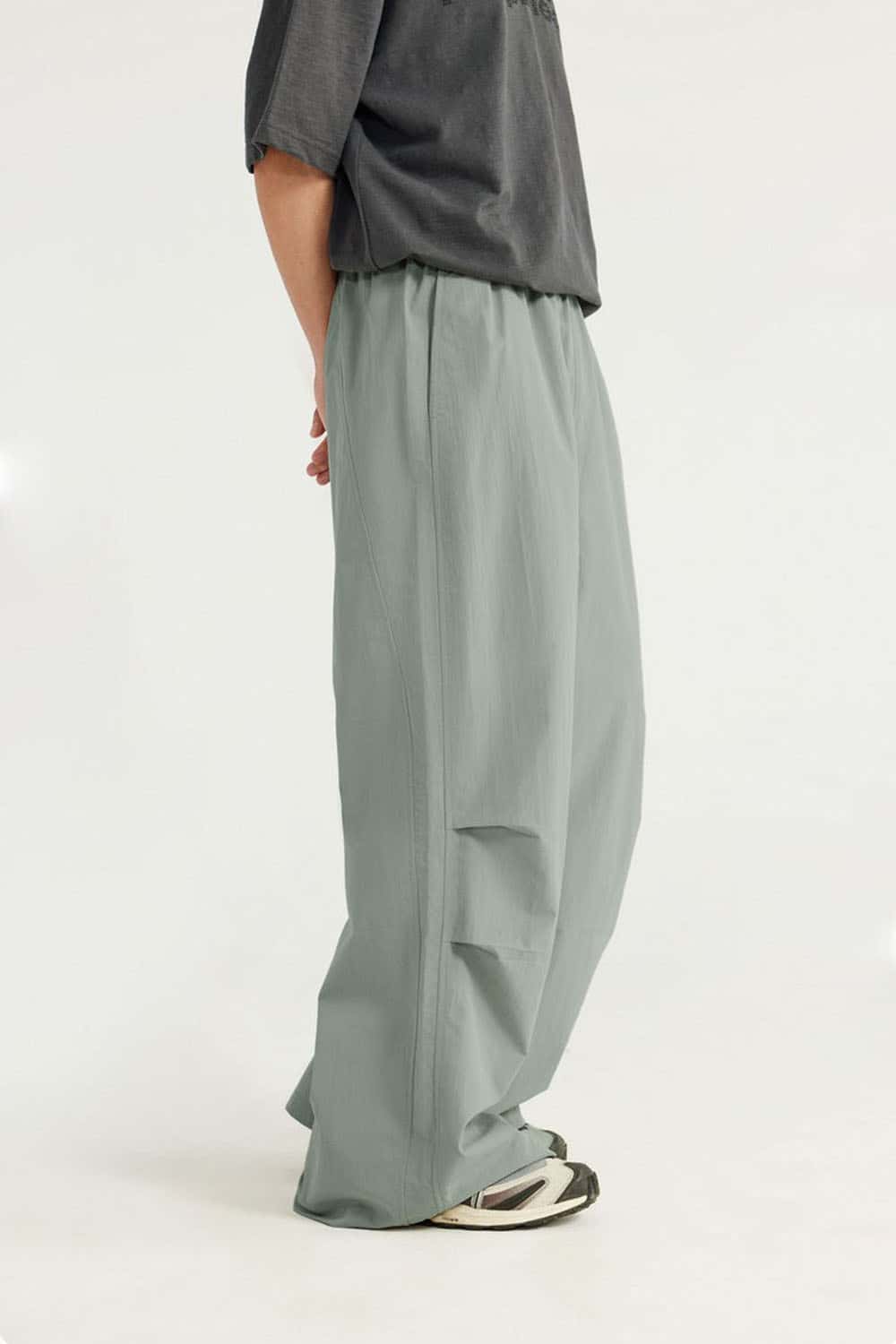 Layered-Pocket Drawstring Wide-Leg Pants in Grayish Green - back modeled view