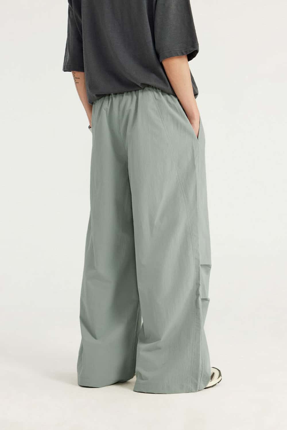 Layered-Pocket Drawstring Wide-Leg Pants in Grayish Green - full-length back modeled view