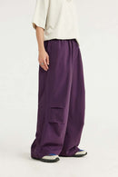 Layered-Pocket Drawstring Wide-Leg Pants in Purple - front modeled view