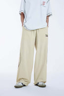 Curved-Panel Graphic Wide-Leg Pants in Light Khaki - front modeled view
